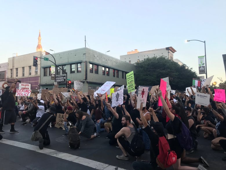 Demonstrators kneel at the intersection of 10th and J streets Thursday, June 4, 2020.