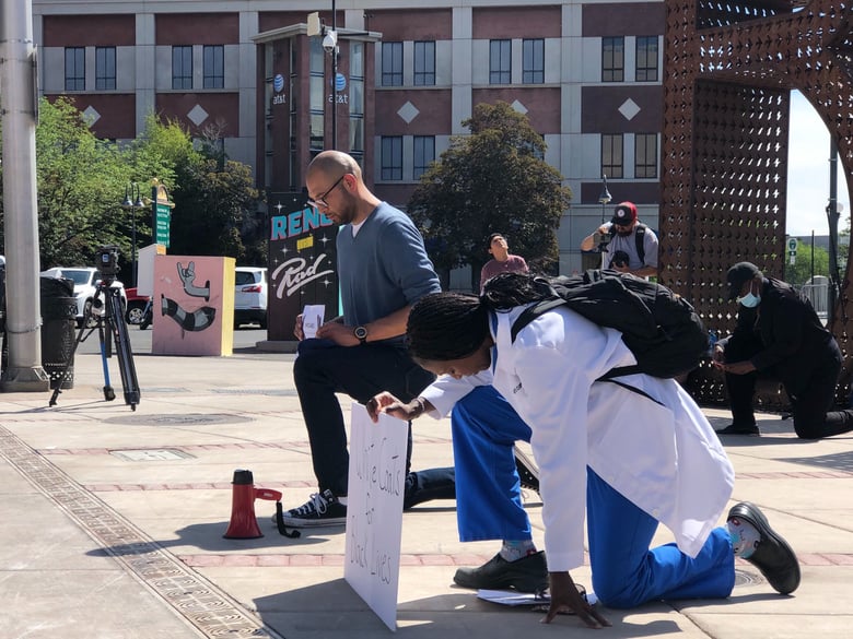 Reno City Councilman Oscar Delgado (left) and Dr. Bayo Curry-Winchell of Saint Mary's Medical Group observe a long moment of silence in honor of George Floyd on Friday, June 5.