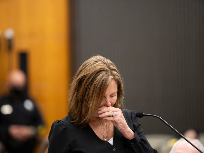 Kris Pedretti reads a statement at the podium as Joseph James DeAngelo is in the court room during the first day of victim impact statements at the Gordon D. Schaber Sacramento County Courthouse on Tuesday, Aug. 18, 2020, in Sacramento, Calif.