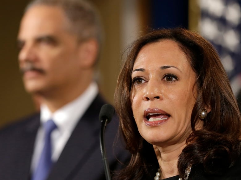 FILE - California Attorney General Kamala Harris, right, accompanied by Attorney General Eric Holder, speaks during a news conference at the Justice Department in Washington, Tuesday, Feb. 5, 2013.