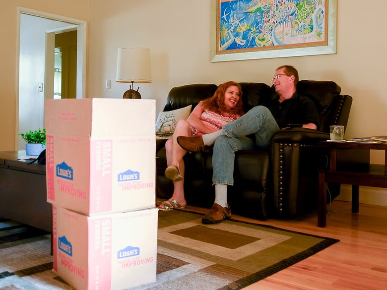 Juliette Saunders, 53, and her fiancee, David Clarke, 60, sit in the living room of their recently sold home in Fullerton on Sept. 15, 2020.