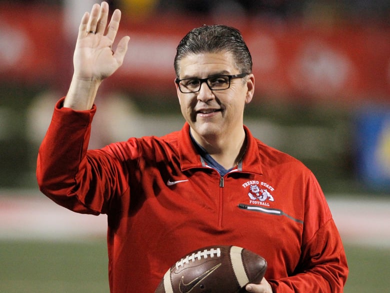 In this Nov. 4, 2017 file photo, Fresno State president Joseph I. Castro waves to the crowd before an NCAA college football game against BYU in Fresno, Calif.