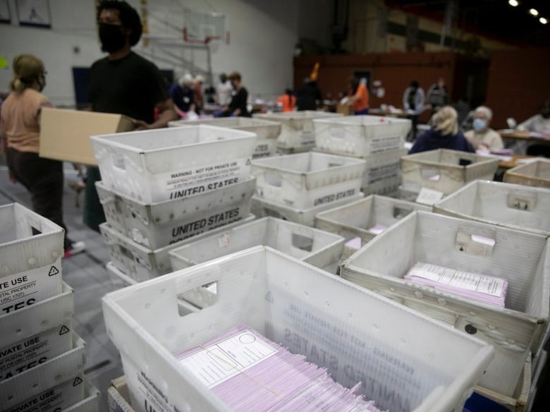 Dozens of volunteers extract ballots at the sports complex in Martinez on Oct. 31, 2020.