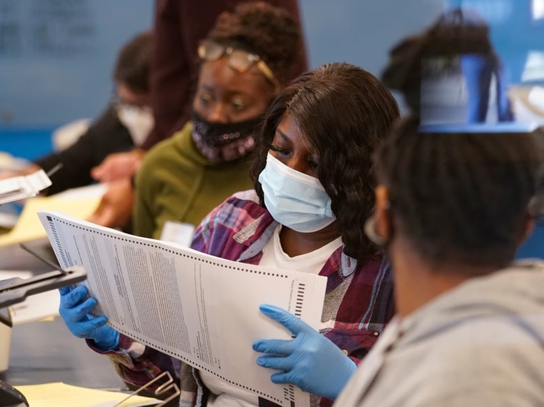Officials work on ballots at the Gwinnett County Voter Registration and Elections Headquarters, Friday, Nov. 6, 2020, in Lawrenceville, near Atlanta.