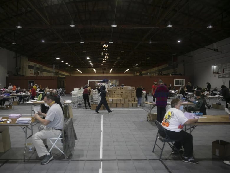 Dozens of volunteers extract ballots at the sports complex in Martinez on Oct. 31, 2020. By Halloween, Contra Costa County had already received more ballots than the total number in the March primary.