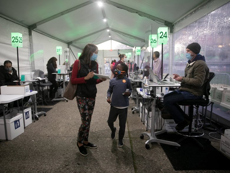 Jackie Bustamante, with her son Peter, 8, prepares to vote at San Francisco Voting Center on Nov. 3, 2020.