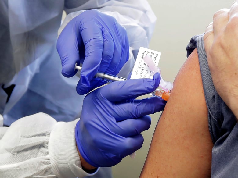 In this March 16, 2020, file photo, a patient receives a shot in the first-stage safety study clinical trial of a potential vaccine for COVID-19, the disease caused by the new coronavirus.