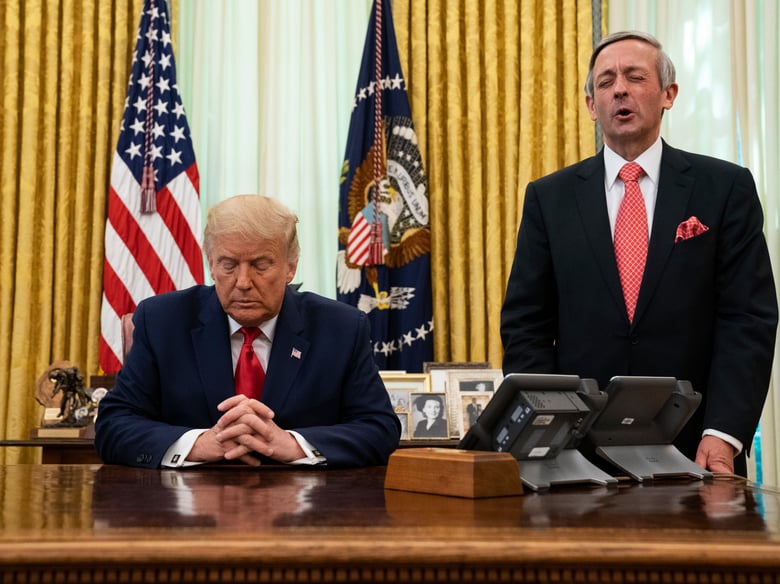 Pastor Robert Jeffries and President Donald Trump pray after Trump signed a full pardon for Alice Johnson for a non-violent drug offense, in the Oval Office of the White House, Friday, Aug. 28, 2020, in Washington.