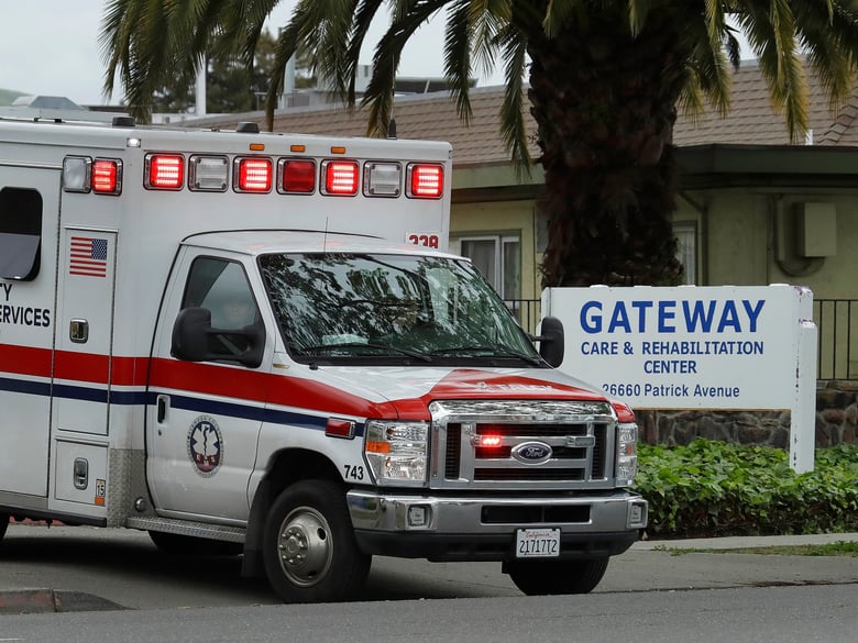 An ambulance leaves the Gateway Care and Rehabilitation Center on Thursday, April 9, 2020, in Hayward, Calif. Nursing homes are one of the highest-risk centers for coronavirus outbreaks, with several hundred patients infected throughout California.