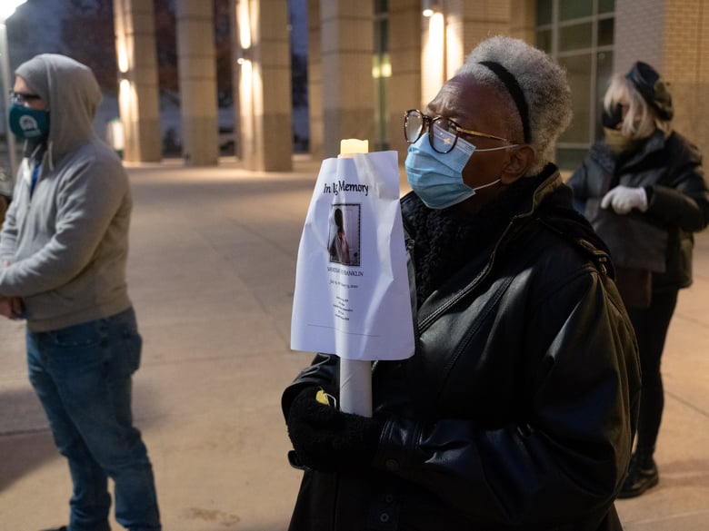 Faye Wilson Kennedy holds a sign remembering Vanessa Diane Franklin, who died earlier this year, Monday, December 21, 2020.