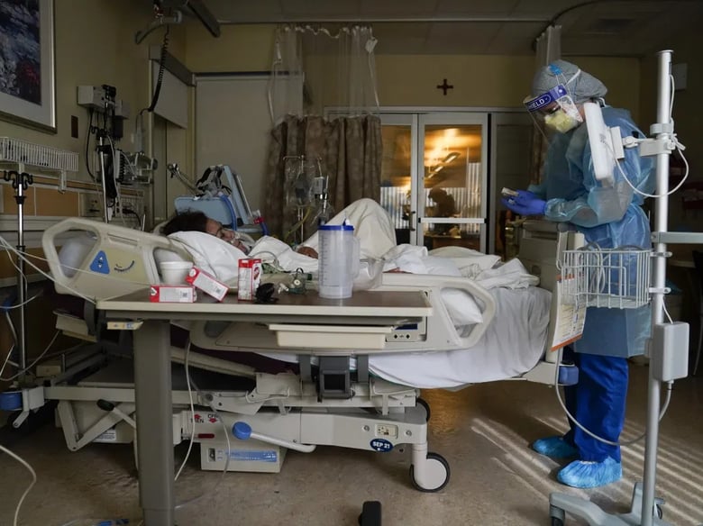Registered nurse Merri Lynn Anderson tends to a patient in a COVID-19 unit at St. Joseph Hospital in Orange, Jan. 7, 2021.