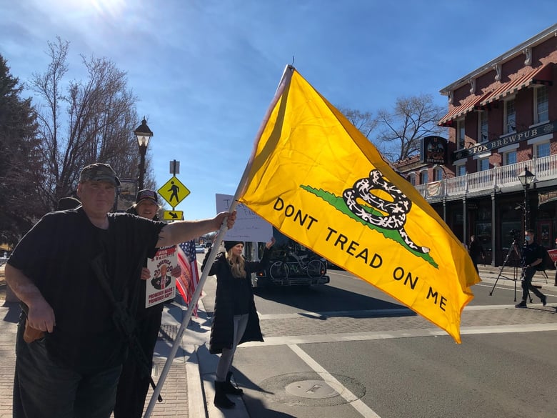 Carson City resident JT poses with his AR-15 and Gadsden flag during a pro-Trump protest on Jan. 20, 2021.