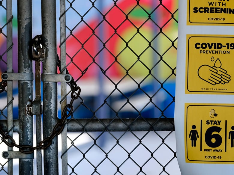 In this July 13, 2020, file photo, a gate is locked at the closed Ranchito Elementary School in the San Fernando Valley section of Los Angeles.