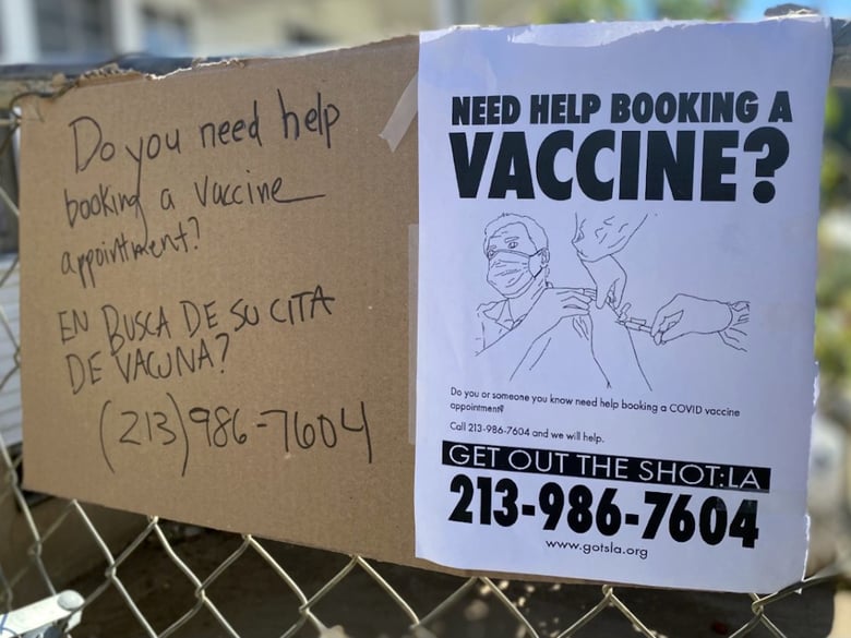 Liz Schwandt co-founded a volunteer group to help Los Angeles residents book vaccine appointments. She hung these signs on her fence to advertise the free services.