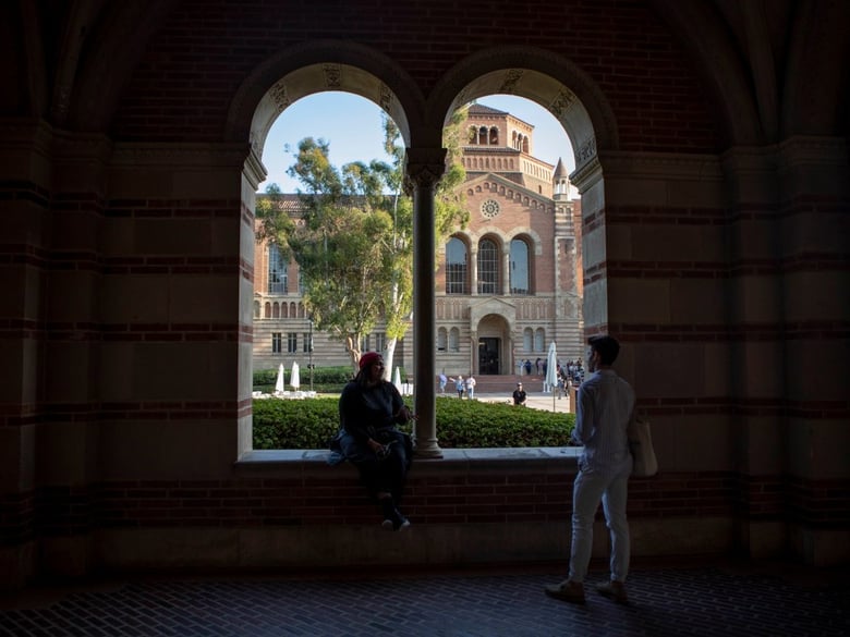 Students sit outside of Royce Hall at UCLA — among the University of California campuses that could experience tuition hikes every year under a pending proposal.