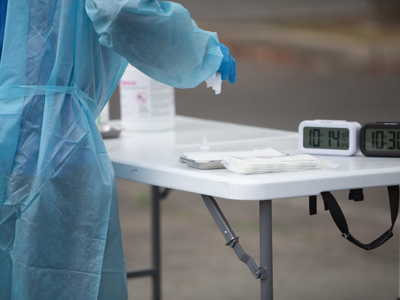 A Curative employee sanitizes a COVID-19 testing area at Cal Expo, on Jan. 6, 2022.