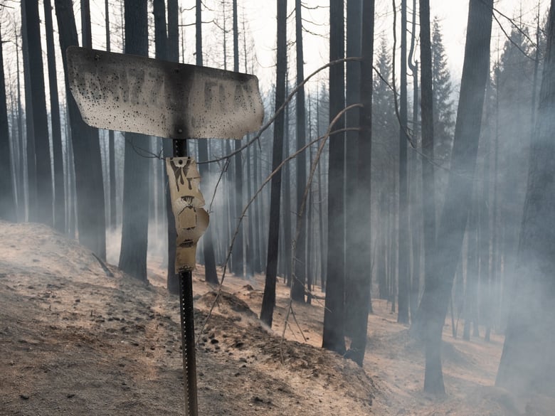 A burned sign greets travelers in Grizzly Flat, Calif. Tuesday, August 17, 2021.