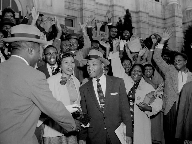 The Rev. Ralph Abernathy (left) shakes hands with the Rev. Martin Luther King Jr. in Montgomery, Ala., on March 22, 1956, as a big crowd of supporters cheers for King, who had just been found guilty of leading the Montgomery bus boycott.