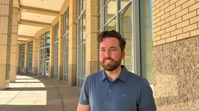 Sacramento resident Alex Enright poses outside city hall, one of the places he used to sleep when he was homeless, on July 6, 2026.