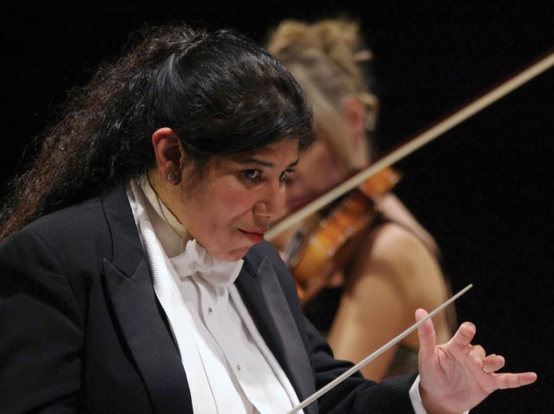 Conductor Sonia Marie De Leon De Vega celebrates 20 years of the community-focused Santa Cecilia Orchestra in 2014. 