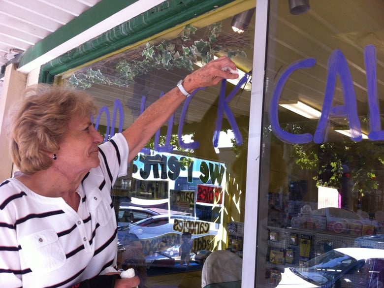 Denise Berg touches up a hand-painted sign supporting the horse. Berg co-owns Pelton's Party Rental in Yuba City. 