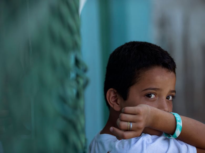 In this Wednesday, June 18, 2014 photo, Edwin Lemus, 10, from El Salvador, sits in the men's section of a shelter providing temporary refuge to Central American migrants on their way north, in Arriaga, Chiapas State, Mexico. 