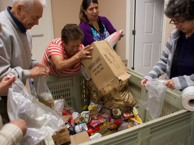 Volunteers at the Ebenezer Christian Center prepare food for distribution.  Many volunteers also receive groceries from the food bank.
