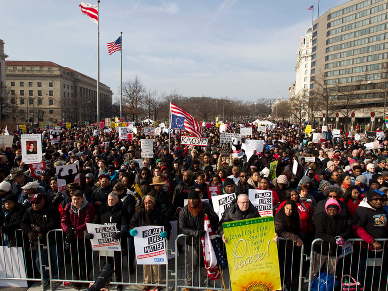 Demonstrators chant at Freedom Plaza in Washington, Saturday, Dec. 13, 2014, during the Justice for All rally and march.