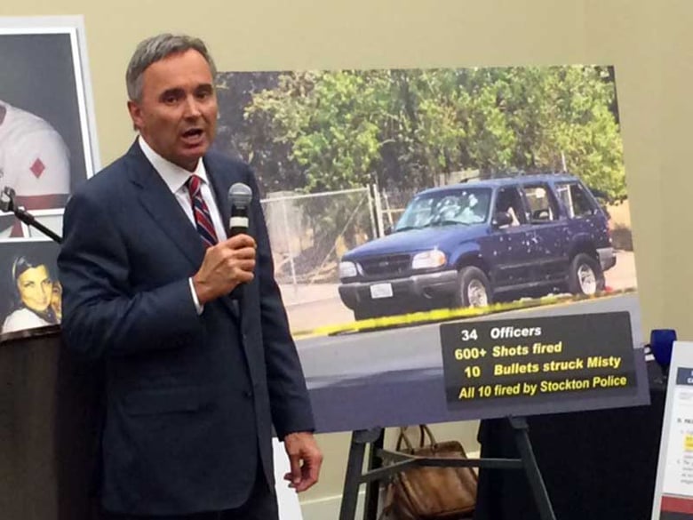 Attorney Gregory Bentley with a photo of the vehicle in which Misty Holt-Singh died after being struck by 10 bullets fired by Stockton police. A shoot-out followed a failed bank robbery in July 2014.  