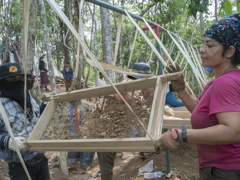 U.S. Army Staff Sgt. Patricia Loayza, Joint POW/MIA Accounting Command Delta Team recovery supervisor, clears a screen full of rock and debris as part of recovery efforts in Laos. 