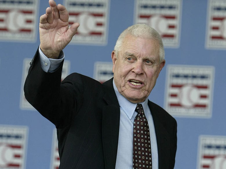 In this July 25, 2004, file photo, broadcaster Lon Simmons, the longtime voice of baseball in the San Francisco Bay area, waves at the end of the 2004 National Baseball Hall of Fame induction ceremonies in Cooperstown, N.Y. 
