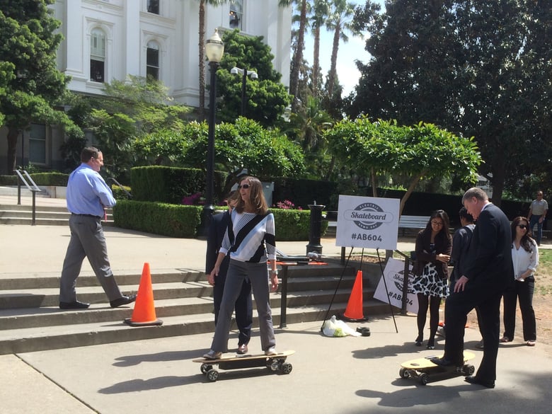 Assembly Minority Leader Kristin Olsen (R-Modesto) and Asm. Mark Stone (D-Santa Cruz) try riding electric skateboards outside the state Capitol Monday.