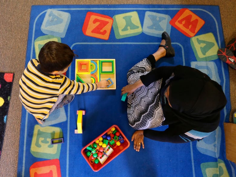 Declan Hart, 4, left, and teacher-in-training Deassi Usman, right, play with shape blocks during a Pre-Kindergarten class at the Community Day Center for Children, during class Tuesday, Oct. 21, 2014, in Seattle.