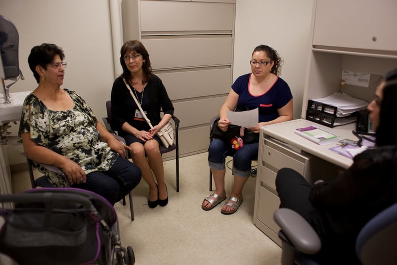 Gloria R. Lopez, left, talks to Licensed Clinical Social Worker Uzma Nazir, far right, through Medical Interpreter Fabiola Cardenas, second from left.