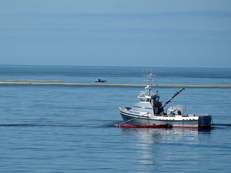 Crews in boats collect oil contained in booms at Refugio State Beach, north of Goleta, Calif., Wednesday, May 20, 2015.  