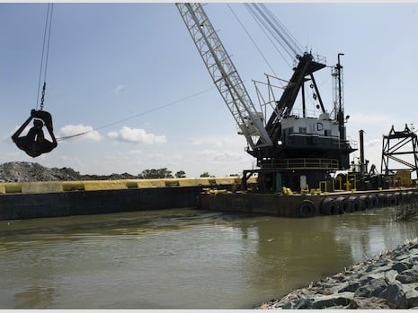 Rock removal from a barge in the West False River in the Sacramento-San Joaquin Delta to construct the 750-foot-wide rock barrier to help deter saltwater from San Francisco Bay into the central Delta. Photo taken May 8, 2015