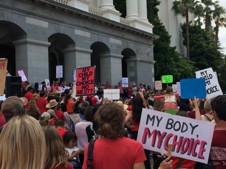 People rally in opposition to a bill requiring mandatory vaccinations for California school children on Tuesday, June 9, 2015. 