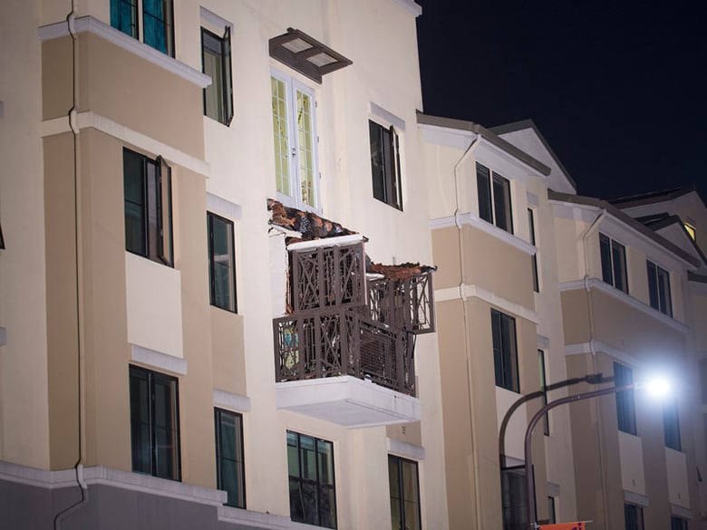 A fourth-floor balcony rests on the balcony below after collapsing at the Library Gardens apartment complex in Berkeley, Calif., early Tuesday, June 16, 2015.  