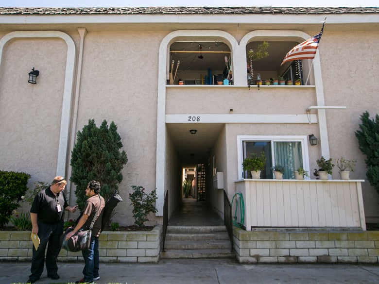 Members of the media gather at a location where a missing woman was found safe in Huntington Beach, Calif., on Wednesday, March 25, 2015.  