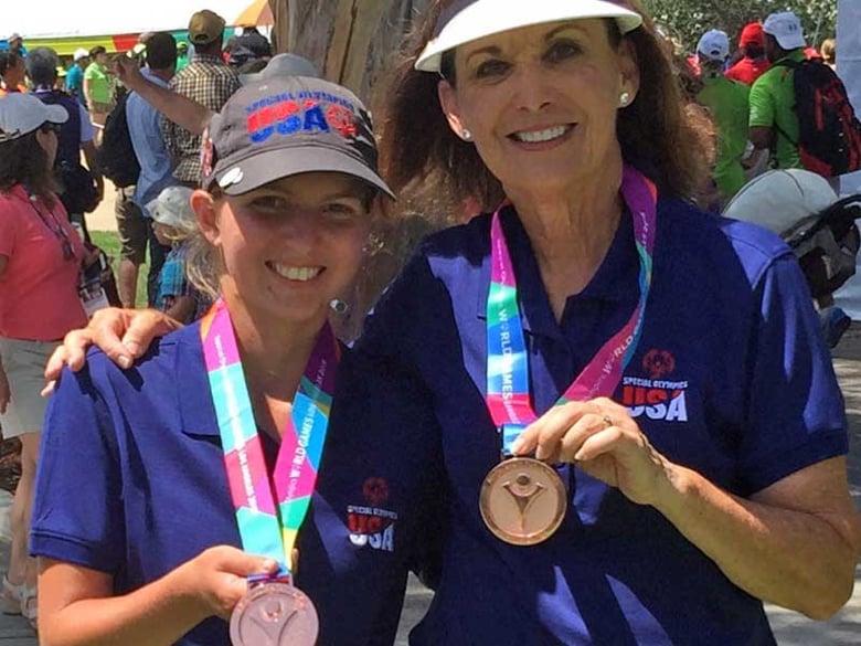 Amber Kasler, left, and Heidi Matlack celebrating their bronze medal win in 9-hole alternate shot golf event at the Special Olympic World Games in Los Angeles.

