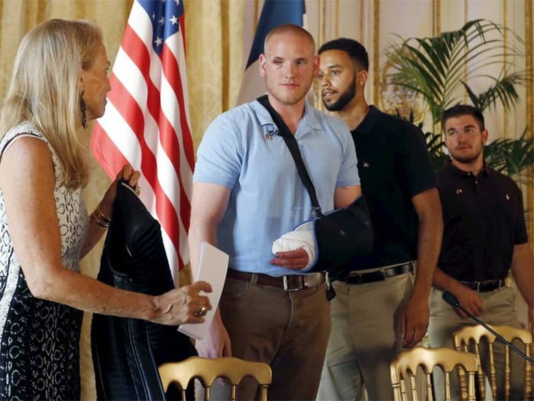 U.S. ambassador to France Jane Hartley presents U.S Airman First Class Spencer Stone, student Anthony Sadler and National Guardsman Alek Skarlatos (left to right) as they attend a news conference at the U.S. Embassy in Paris, France, on Sunday.