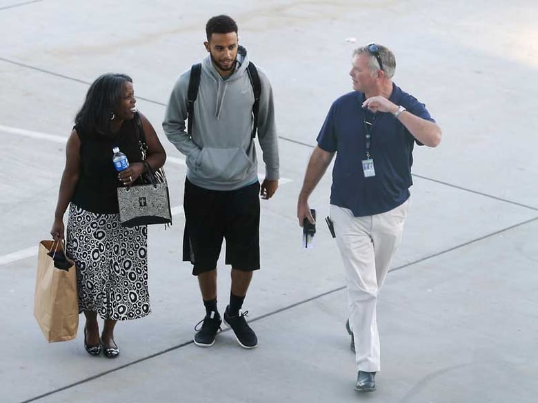 Anthony Sadler, center, who helped stop a terror attack on a high-speed train traveling from Amsterdam to Paris, walks across the tarmac to a waiting vehicle at Sacramento International Airport, Tuesday, Aug. 25, 2015.