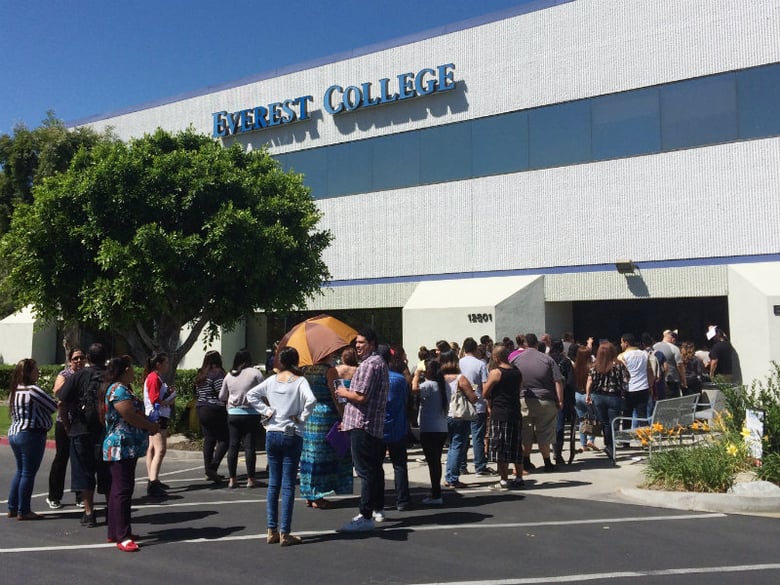 Students wait outside Everest College, Tuesday, April, 28, 2015 in Industry, Calif., hoping to get their transcriptions and information on loan forgiveness and transferring credits to other schools.