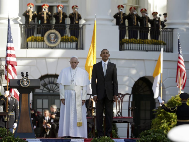 President Barack Obama and Pope Francis stand at attention during the playing of the national anthems during a state arrival ceremony for the pope, Wednesday, Sept. 23, 2015, on the South Lawn of the White House in Washington.  