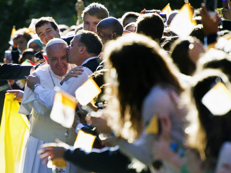 A man kisses Pope Francis while he greets well-wishers outside the Apostolic Nunciature, the Vatican's diplomatic mission in Washington, Wednesday, Sept. 23, 2015.