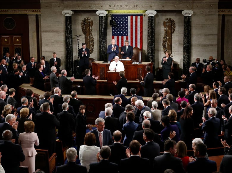Members of the House and Senate applause as Pope Francis begins his address before a joint meeting of Congress on Capitol Hill in Washington, Thursday, Sept. 24, 2015, making history as the first pontiff to do so.