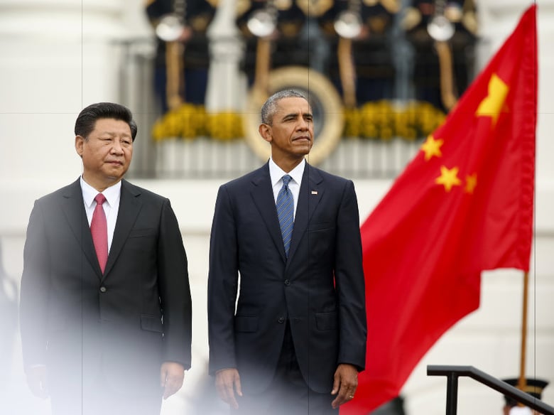 President Barack Obama and Chinese President Xi Jinping stand on stage and watch the Fife and Drum Corps march past them during an official state arrival ceremony for the Chinese president, Friday, Sept. 25, 2015.