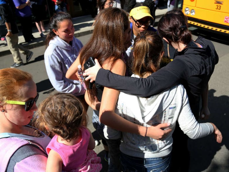 Friends and family are reunited with students at the local fairgrounds after a mass shooting at Umpqua Community College, in Roseburg, Thursday, Oct. 1, 2015. Multiple people were killed after a gunman opened fire at the campus early Thursday.