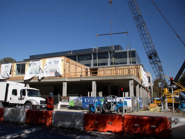 A 250-ton crane lifts apartment units into place at 16th and N Streets in Sacramento. A new report suggests finding more new apartment projects like this in Sacramento won't get easier.