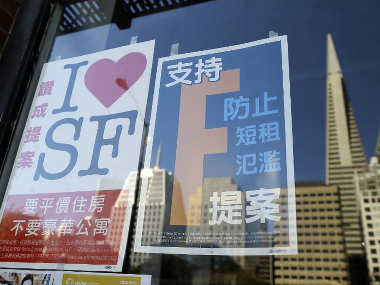 In this photo taken Thursday, Oct. 29, 2015, are election signs in a Chinatown window supporting affordable housing in the Mission District and restrictions on short term rentals in San Francisco.